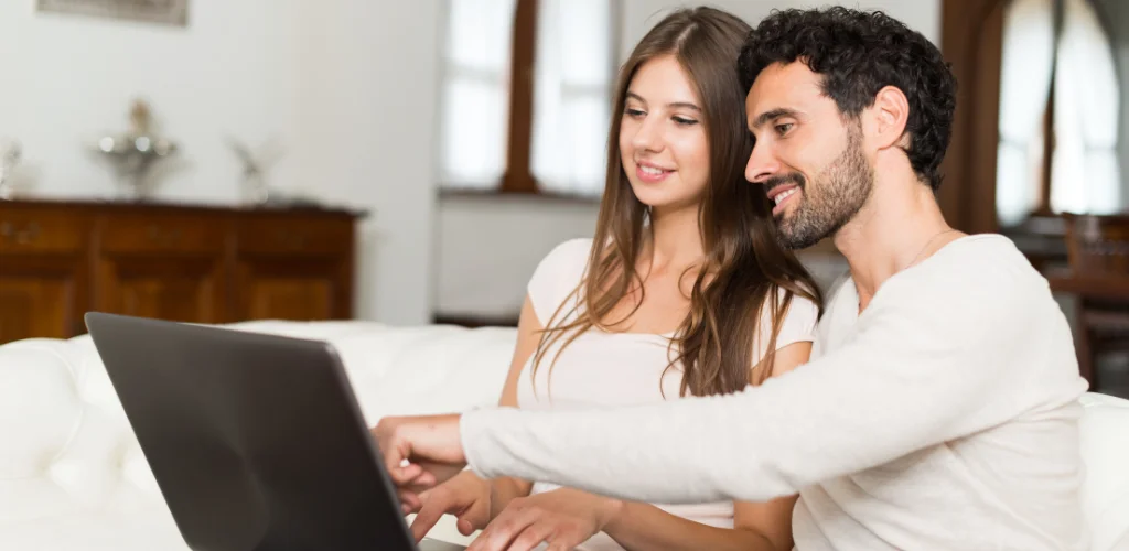 Couple sitting in a couch reviewing home insurance options in Australia 2025
